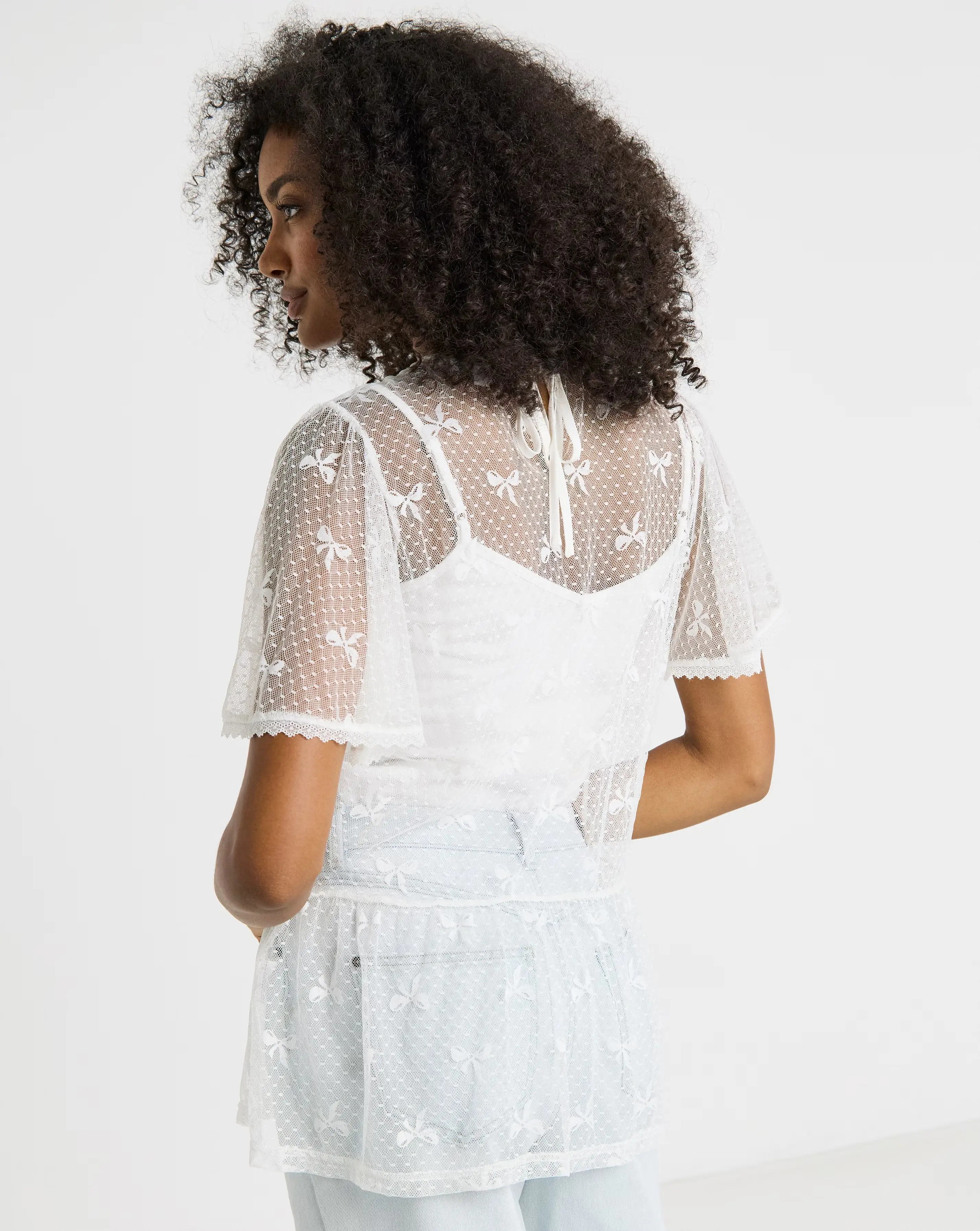 46848-simply-be-ivory-bow-print-lace-top-1.webp
