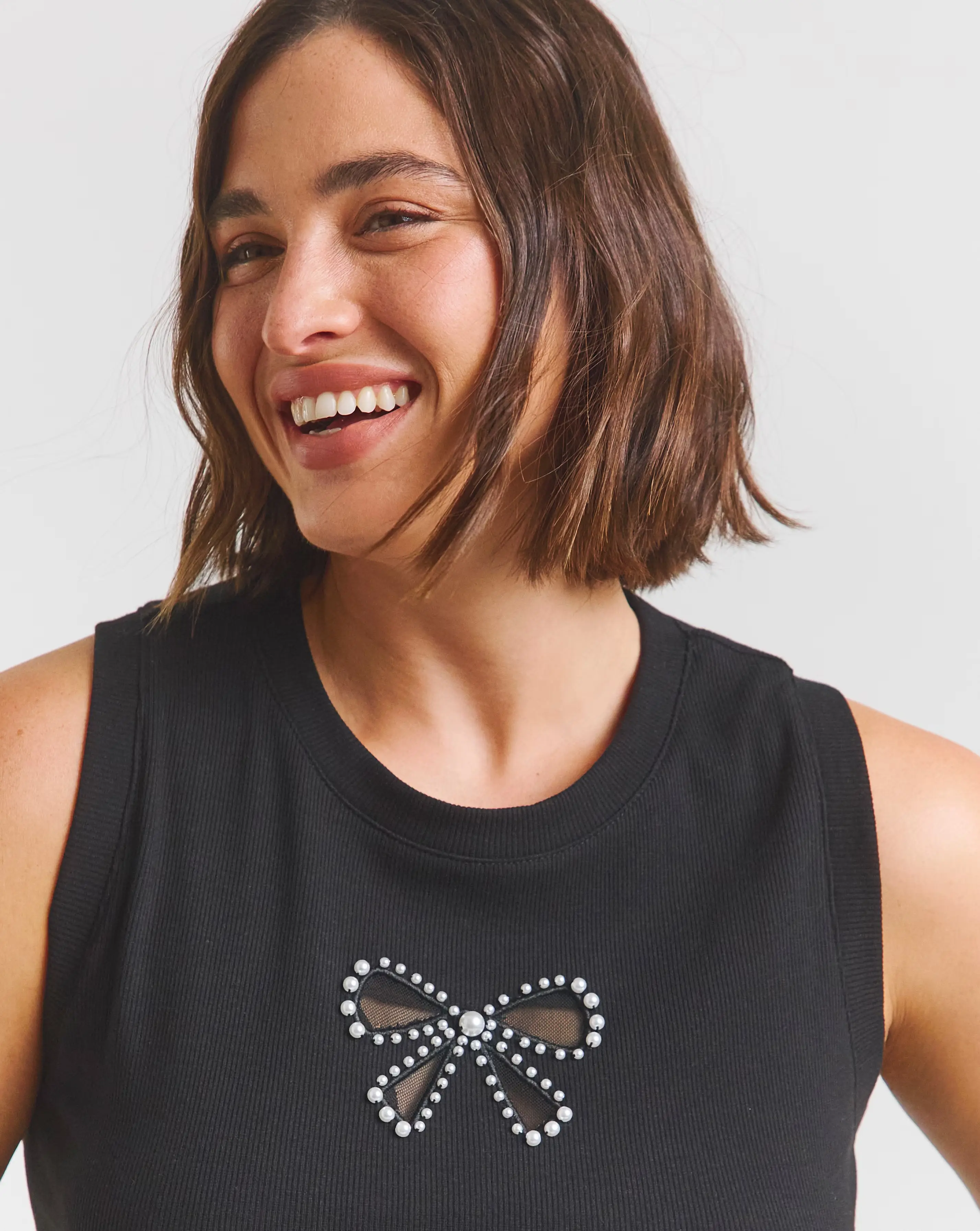 47407-black-bow-cut-out-tank-with-pearls-1.webp